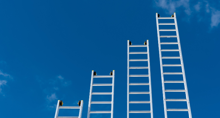 Aluminum ladders ascending into clear blue sky