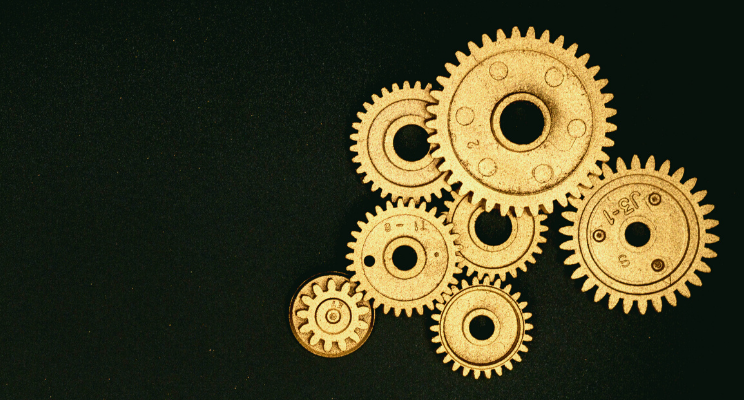 Golden mechanical gears on black background