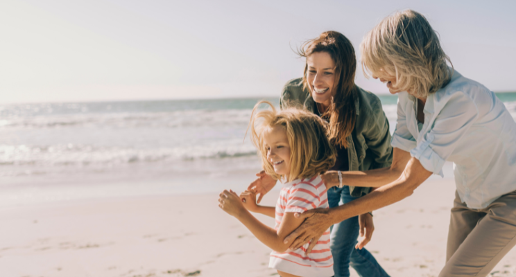 Smiling family playing on sunny beach