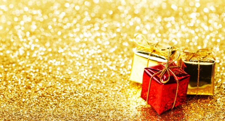 Small red and gold gift boxes on glitter