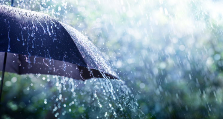 Umbrella in heavy rain with splashing droplets