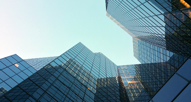 Glass skyscrapers reflecting blue sky