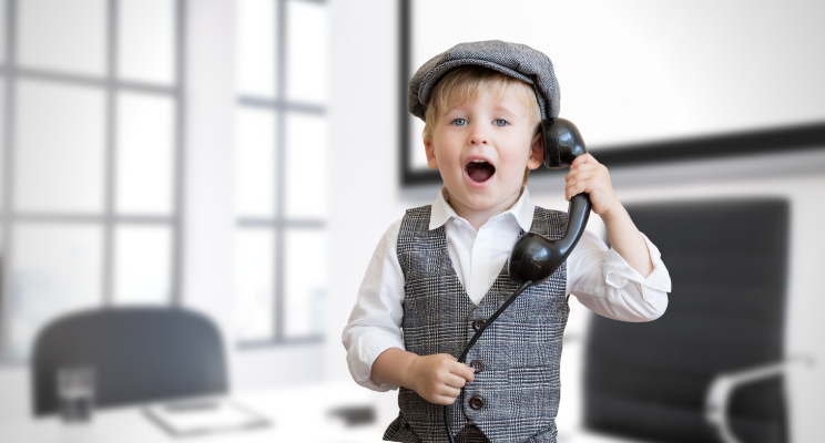 Boy in newsboy cap talking on telephone