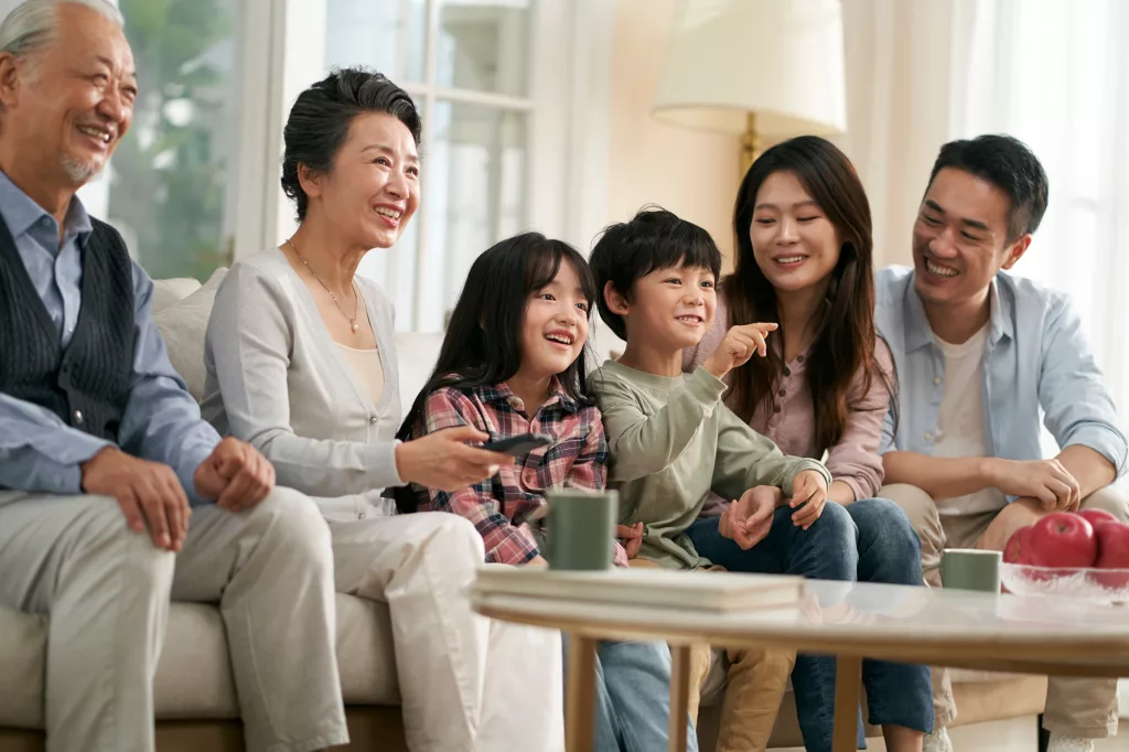 A stock image of many generations of an asian family enjoying free time together, illustrative of Mainstream's HNW and comfortable Los Angeles clients who need wealth management that transcends the normal.