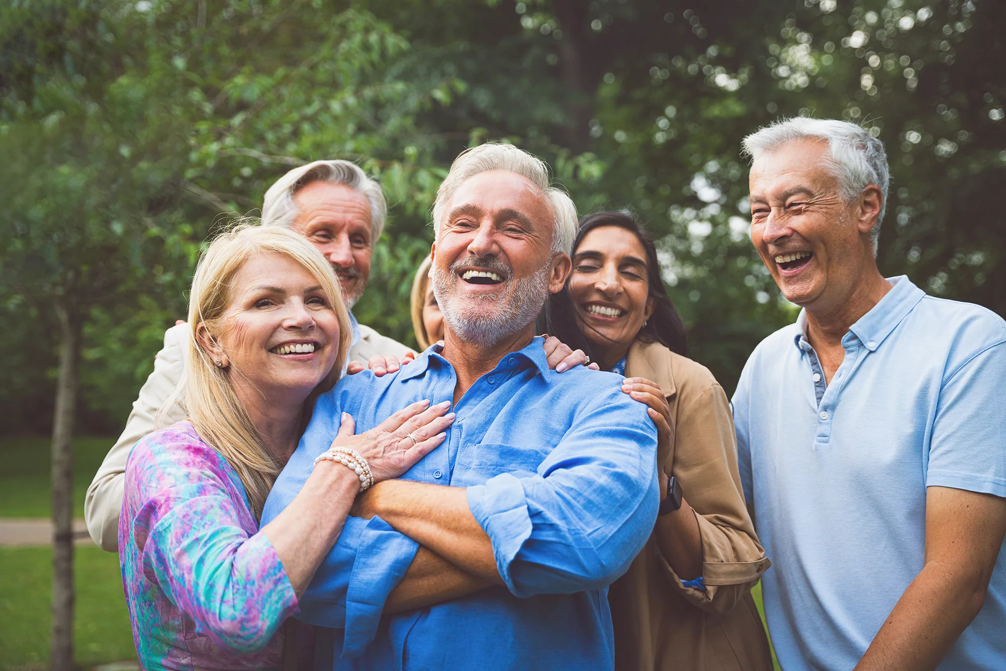 A stock image of a group of happy, well-off retirees enjoying time together, illustrating Mainstream Capital Management's Mission Statement.